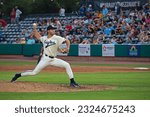Small photo of CHARLESTON, SC, USA - JUNE 24, 2023: Matt Wyatt, of the Minor League Baseball team Charleston RiverDogs and wearing a throwback uniform, delivers a pitch during a game at Joseph P. Riley Jr. Park.
