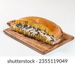 Small photo of Martabak manis or terang bulan is indonesian sweet pancake, with yellow color and filled with chocolate chips, cheese, fruit jam, butter and peanut on white background.