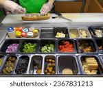 Chef preparing a live sandwich in a restaurant kitchen with vegetables. Fresh veggies. Live fresh food. 
