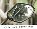 Motorcycle rearview mirror cracked with reflection