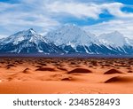Snowy mountains in the distance beyond the desert, with a cloudy sky