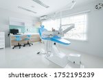 Modern style interior shot of dental clinic with blue dental chair.