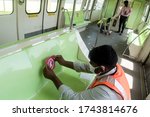 Small photo of MUMBAI/INDIA -MAY 28, 2020: Worker fixes a sticker showing the measures for the social distancing as a preventive measure against the COVID-19 corona virus. MMRDA is preparing to resume its services
