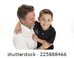 Small photo of a father and son / engage themselves in horseplay / whilst on white background