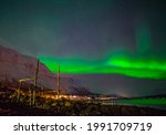 Aurora northern lights in Sjursnes is a village in Tromsø Municipality in Troms og Finnmark county, Norway. The village is located along the Ullsfjorden.