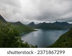 Beautiful Norwegian fjord landscape. On the background Fjordgard village and famous Segla mountain. Fish farms on the sea.