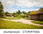 Summer sunny day in a russian village. The landscape depicts old wooden houses, trees and shrubs. Image with selective focus.
