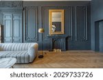 chic interior of the room in the Renaissance style of the 19th century with modern luxury furniture. walls of noble dark color are decorated with stucco and gilded frames, wooden parquet.