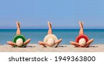 Small photo of Three young girls on the beach wearing straw hats in the color of the flag of Italy. Ideal vacation concept in a resort in Italy. Focus on hats.