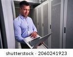 Small photo of Colocation data center engineer working on notebook computer