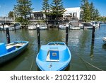 Small photo of Mordialloc, Victoria, Australia - December 2021: Small boats on Mordialloc Creek in Melbourne's bayside, with diners on the deck of the Bridge Hotel on the far side.