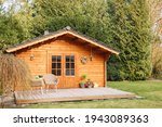 Small photo of Wooden garden shed with terrace. Wooden garden shed. Life in the country in Germany in summer. Vacation in the country.