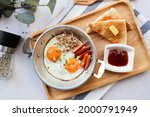Fried Eggs In A Small Pan With...