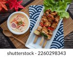 Small photo of Yakitori and Chawan Mushi - Japanese chicken skewer and steamed egg flat lay on wood table at top view