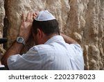 Small photo of Prayer at the Western Wall A religious man prays at the Western Wall A Jewish man cries and begs praying at the Western Wall A Jewish man prays at a relic to Solomon's temple