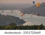 Small photo of Nizhny Novgorod, Russia, 08.17.2023. Aeronautics Festival. City Day in Nizhny Novgorod 2023. Nizhny Novgorod 802 , the capital of sunsets. Balloons in the sky above the city. High quality photo