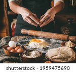woman hands break an egg into... | Shutterstock . vector #1959475690