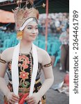 Small photo of Banyuwangi, Indonesia - September 21 2023 : Portrait from the side of a smiling infatuated dancers. Selective focus