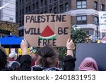 Small photo of New York, NY, USA December 16 2023: Pro-Palestinan Protesters gather in Herald Square for a "March for the Martyrs" Rally. Sign: "Palestine Will be Free" with a watermelon painting.