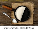 Small photo of Tapioqueira maker with a tapioca inside top view, Iron skillet, cast iron skillet, skillet for making tapioca (Frigideira de tapioca), on wooden table with selective focus, isolated