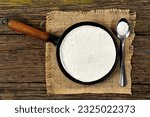 Tapioqueira  maker with a tapioca inside top view, Iron skillet, cast iron skillet, skillet for making tapioca (Frigideira de tapioca), on wooden table with selective focus, isolated