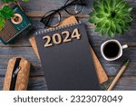 Small photo of New year resolutions 2024 on desk. 2024 goals list with notebook, coffee cup, plant on wooden table. Resolutions, plan, goals, action, checklist, idea concept. New Year 2024 resolutions, copy space
