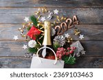 2024 New Year composition. New year holidays card with shopping bag with bottle of сhampagne, festive decorations. Gifts, present, festive New Year 2024 background