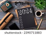 Small photo of New year resolutions 2024 on desk. 2024 goals list with notebook, coffee cup, plant on wooden table. Resolutions, plan, goals, action, checklist, idea concept. New Year 2024 resolutions. Copy space