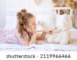 A little child girl at home in...
