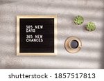 365 new days, 365 new chances. Letter board with motivational quote on grey concrete background with coffee cup. New year resolutions and goal setting, self improvement and development concept. 