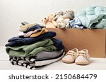 Small photo of Baby and child clothes, toys in box. Second hand apparel idea. Circular fashion, donation, charity concept