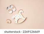 Small photo of Gender neutral baby shoes, rocking horse and teether. Organic newborn fashion, branding, small business idea