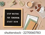 Flatlay of letter board with motivational quote Stop waiting for tomorrow, start now. Office supplies made of recycled materials on beige background