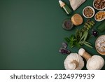 Small photo of Botanical blends, herbs, essencial oils for naturopathy. Natural remedy, herbal medicine, blends for bath and tea on green background