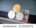 Small photo of Russia Ufa February 2022: Credit card together with cryptocurrency. Bitcoin, Ethereum and Litecoin coins lie on the mastercard. Electronic money, the world's zealot. High quality photo