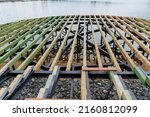 Small photo of Pier construction on the water, construction of a wooden pier, a pattern of boards, construction work on the lake, the city pond ennoble. High quality photo