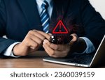 Small photo of System warning hacked alert, cyber attack on computer network.Businessman using mobile phone with warning sign notification error, Malicious software,virus and cybercrime, Cybersecurity,data breach.