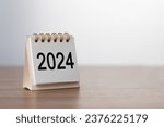 Small photo of 2024 Happy New year background. Turns over a calendar sheet. Setup objective target business cost and budget planning of new year concept. year change from 2023 to 2024.