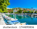 Croatia, city of Rijeka, skyline view from Delta and Rjecina river over the boats in front, colorful old buildings, monuments and Trsat on the hill in background
