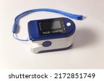 Pulse oximeter on white background. Heartbeat and oxygen level sensor.