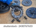 Small photo of disassembled tractor clutch, broken clutch to the walk-behind tractor, disassembled old clutch to the tractor