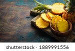 Small photo of sliced juicy pineapples. Ripe baby pineapple. Tropical fruits. Top view. Free space for text.