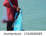 Small photo of In the hands of fishermen carrying nets to prepare to throw overboard is a catch fish method of fishermen in Thailand.