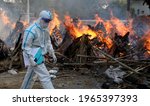 Small photo of New Delhi, India, April 30, 2021: Mass cremation COVID 19 death. A relative wear PPE kit seen during the mass cremation of those who died from the coronavirus disease COVID-19 at a crematorium