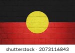 Small photo of Australian Aboriginal Flag flag painted on a brick wall.