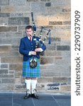 Small photo of Edinburgh, Scotland - November 02 2006: A bagpiper busking with the Great Highland bagpipe on the street in Edinburgh, Scotland.