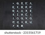Small photo of Blackboard with the Tifinagh Alphabet used by the berber in Morocco drawn in the middle.