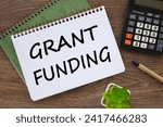 Small photo of Grant funding symbol. Beautiful wooden table. Business financing and grants concept. Copy space.