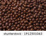 Brown dragee, chocolate covered nuts, background
