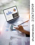 Small photo of Businesswoman or accountant working Financial investment on calculator, calculate, analyze business and marketing growth on financial document data graph, Accounting, Economic, commercial concept.